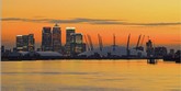 Photo:  Canary Wharf and the Millennium Dome at sunset on the river Thames